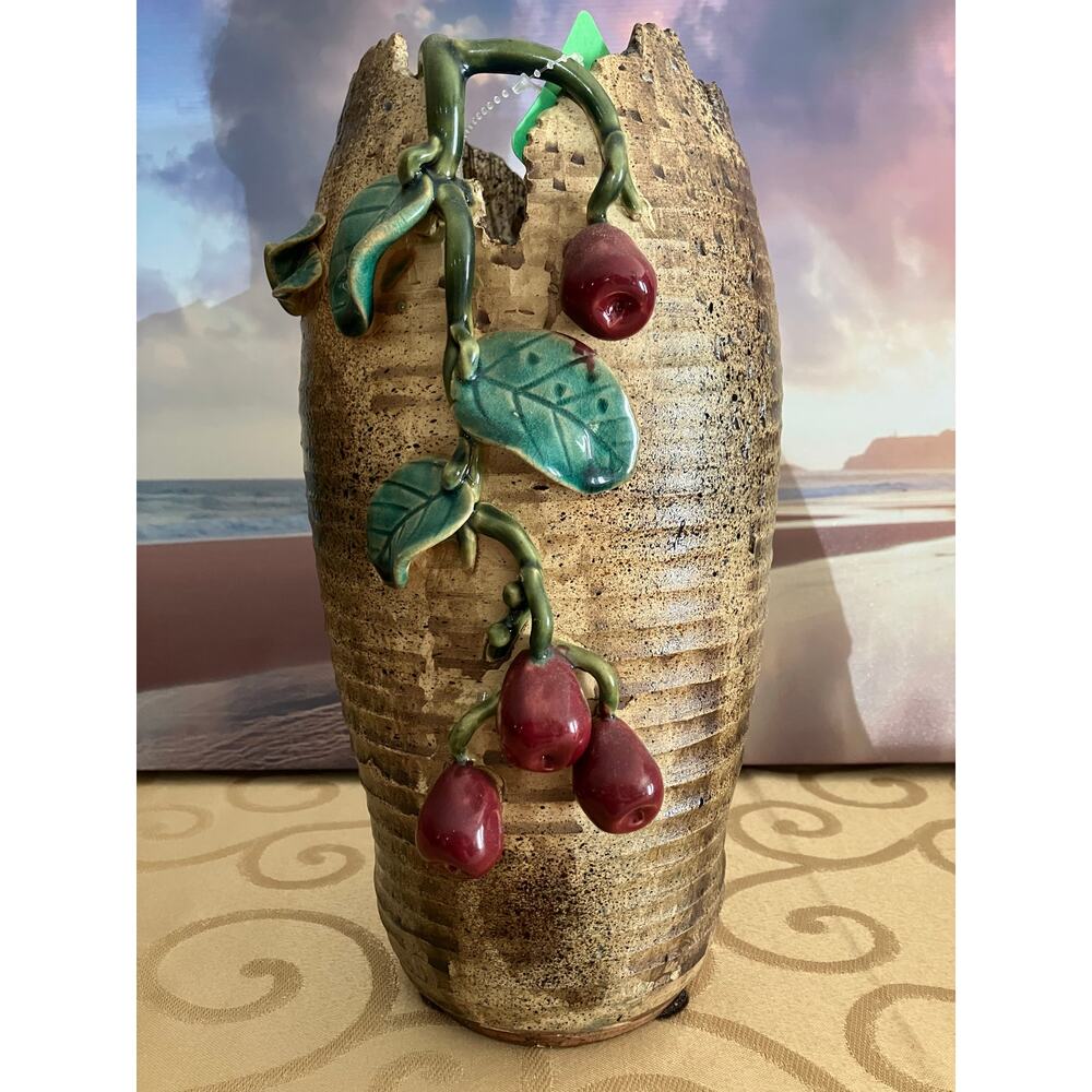 Shiwan pottery vase adorned with deep red cherry and green vines